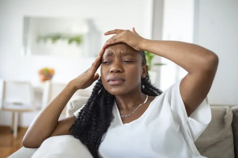 portrait-young-black-girl-sitting-couch-home-with-headache-pain-beautiful-woman-suffering-from-chronic-daily-headaches-sad-woman-holding-her-head-because-sinus-pain-860x573.jpg